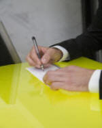 Photo of hands writing on paper